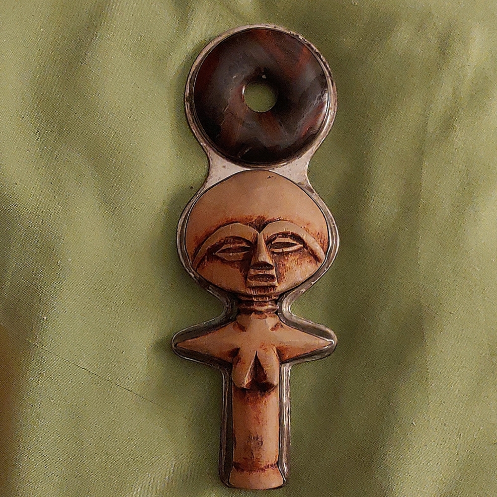 Carved bone and agate fertility pendant on sterling silver pendant.